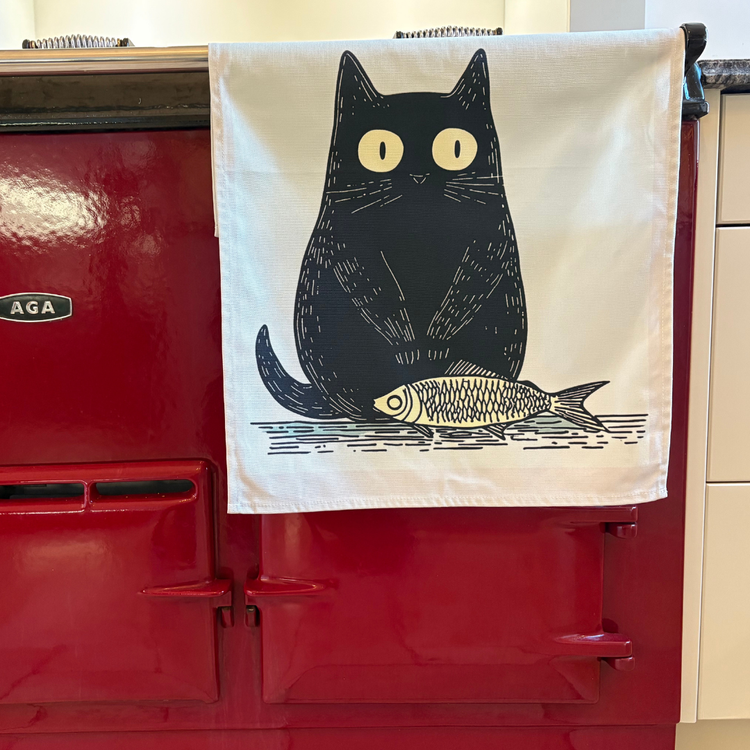 Black Cat With Fish Tea Towel On Red AGA
