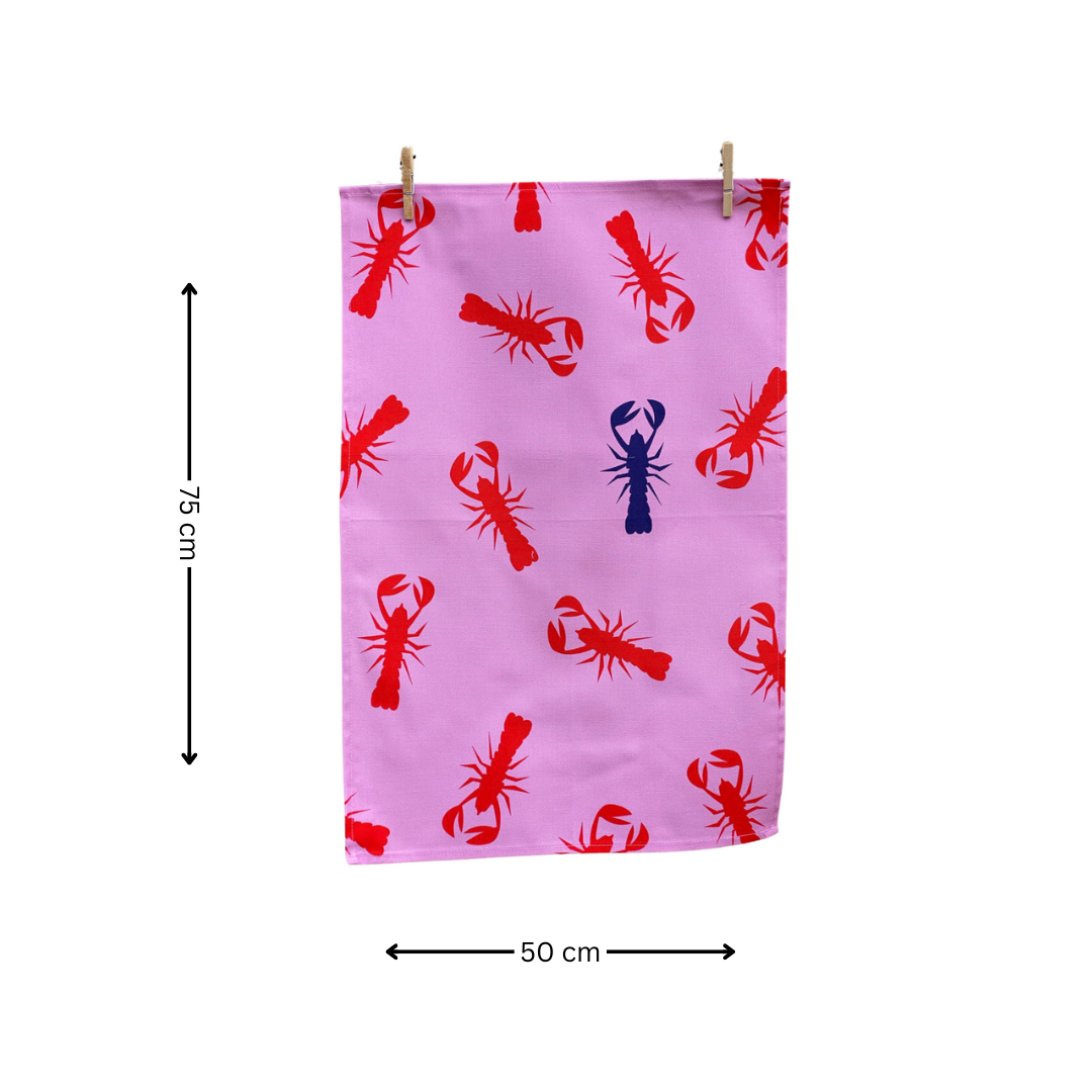 100% Cotton Pink Lobster Tea Towel hanging from pegs and on white background with arrows indicating measurements of 75 cm x 50 cm.