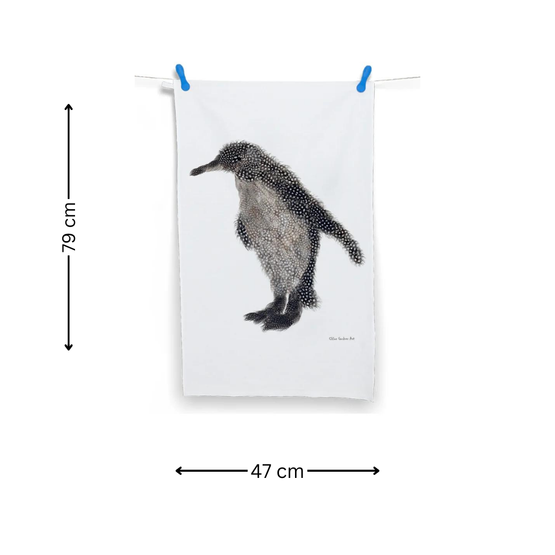 Grey Feather Penguin Tea Towel on washing line with two pegs on white background with arrows indicating the measurements 79 cm x 47 cm.