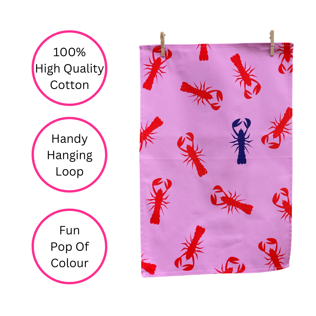 100% Cotton Pink Lobster Tea Towel hanging from pegs and on white background with three pink discs highlighting the benefits, 100% High Quality Cotton, Handy Hanging Loop and Fun Pop of Colour.