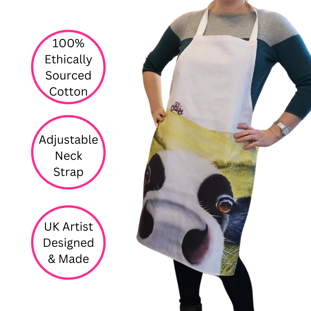 Cow In Pasture Friesian Cow Apron being worn by woman on white background with three discs highlighting 100% ethically sourced cotton, adjustable neck strap and UK artist designed & made.