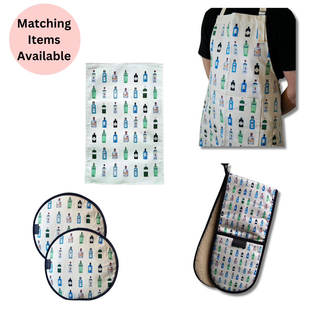 White Gin Tea Towel, White Gin Apron being worn by man, Gin Chef's Pads and White Gin Double Oven gloves on white background with pink disc with the text "matching items available".