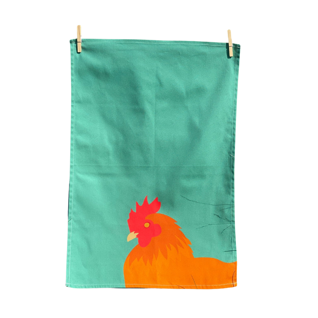 Green Chicken Tea Towel Hanging By Pegs On White Background