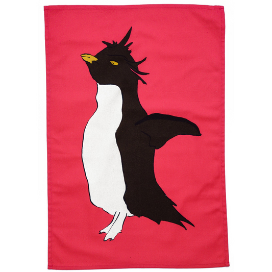 100% Cotton Pink Penguin Tea Towel on white background.