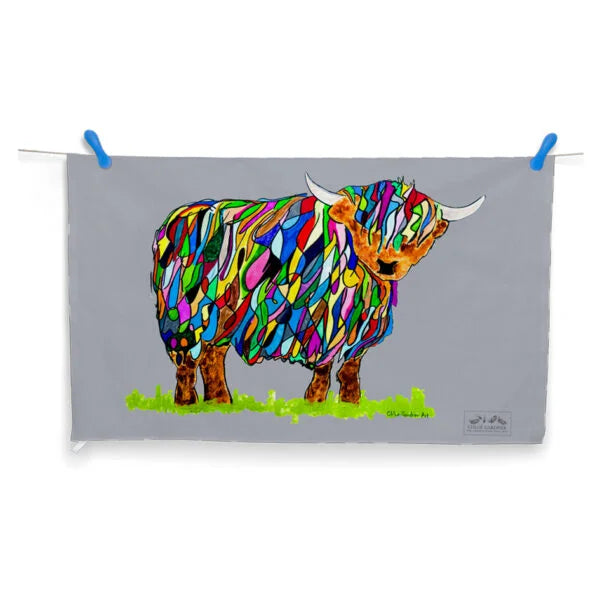 Bright Highland Cow Tea Towel on Grey hanging on washing line with pegs on white background.