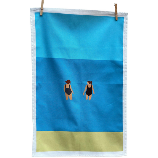 Our Wild Friends Wild Swimming Tea Towel hung on pegs and on white background.