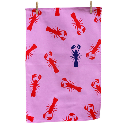 100% Cotton Pink Lobster Tea Towel hanging on pegs on white background.