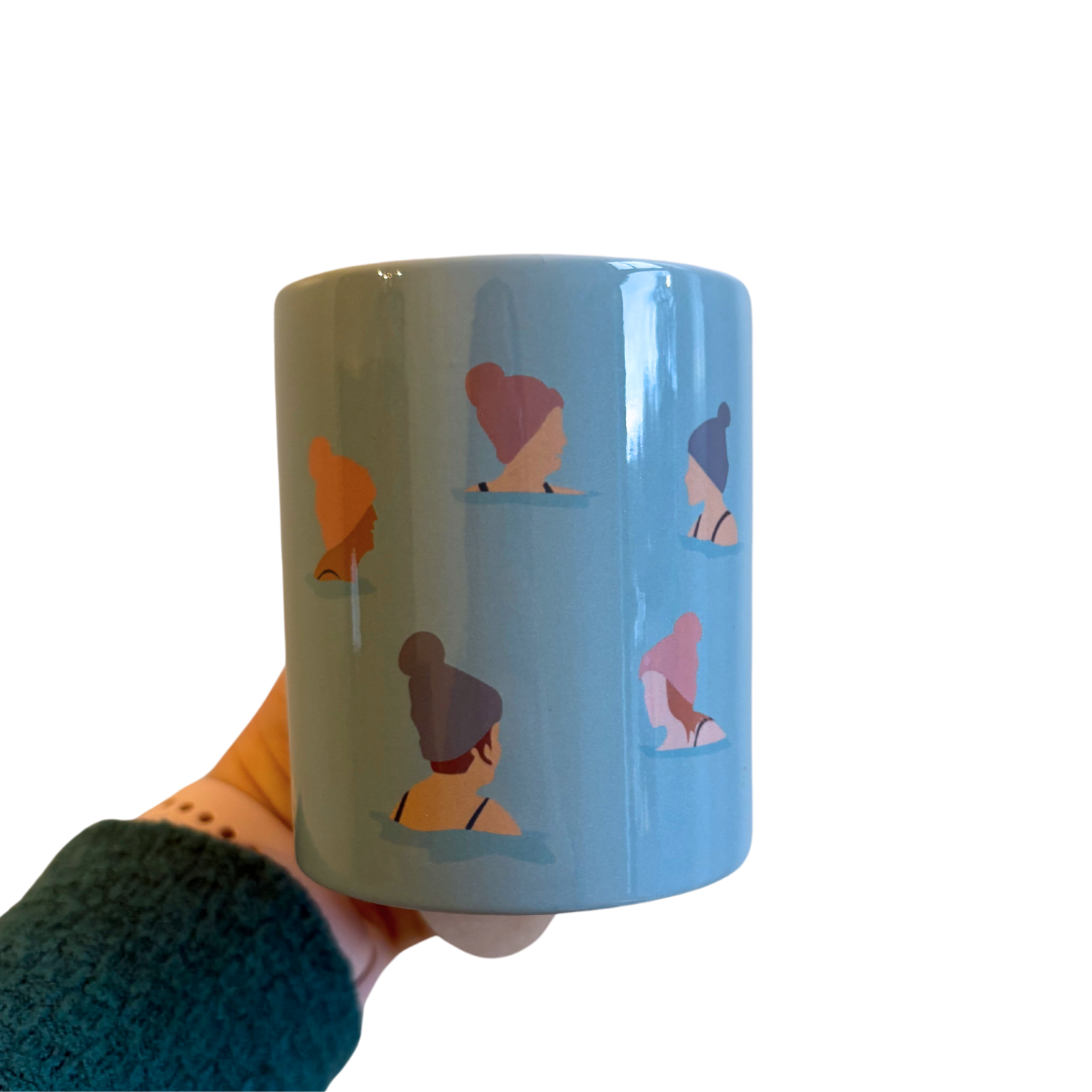 Wild Ones Wild Swimming Mug being held in woman's hand.