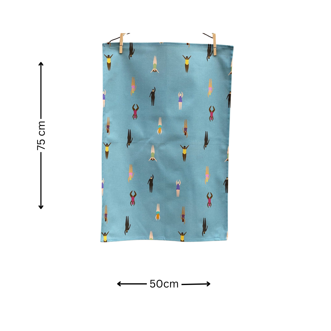 Wild Swimming Tea towel hanging by pegs on white background with black arrows and text to indicate measurements - 75 cm x 50 cm.