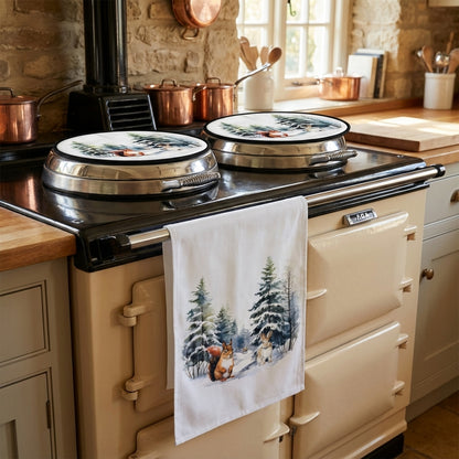 Winter Woodland Animals Chef's Pads and Winter Woodland Animals Tea Towel on cream AGA.