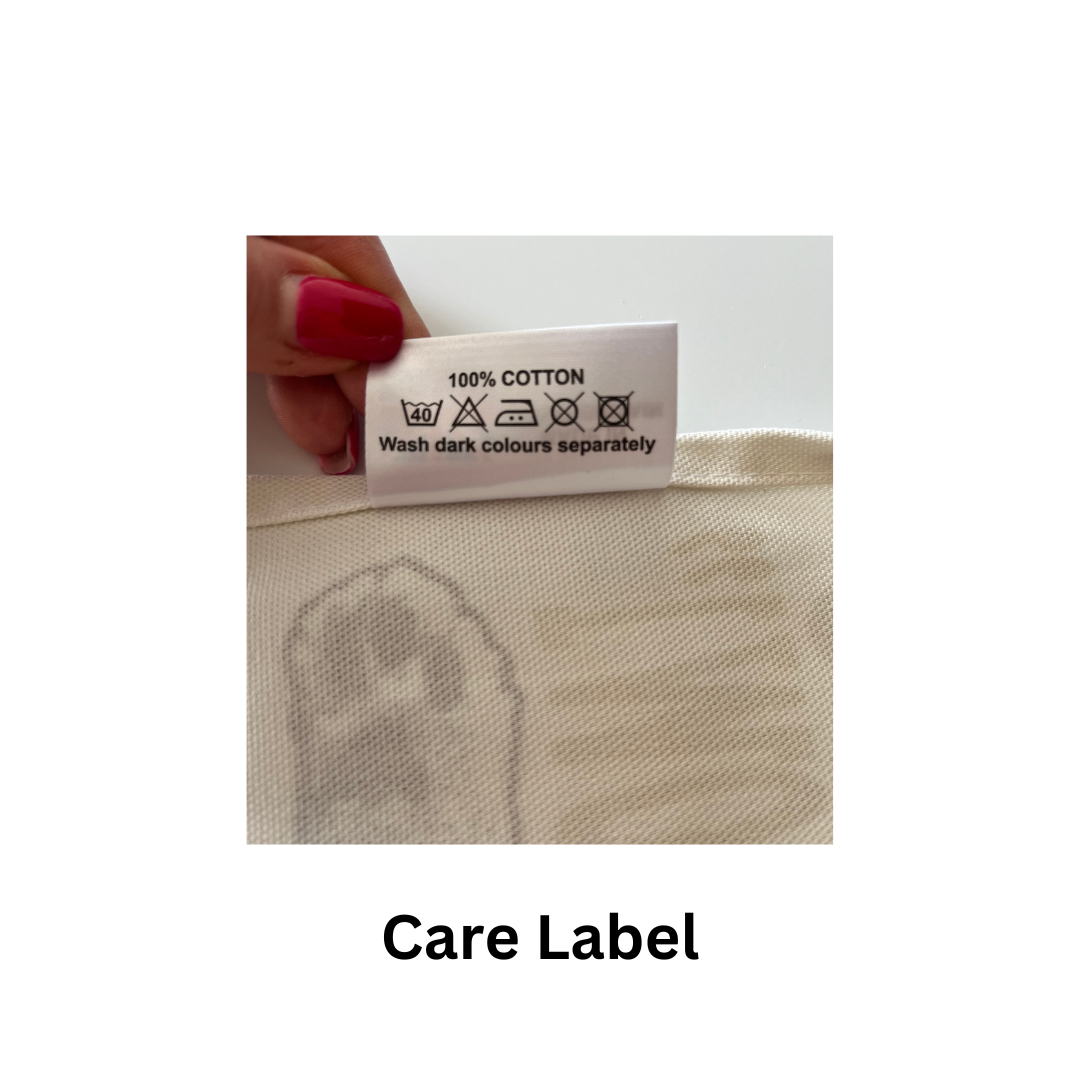 Yellow Hungry Cat Tea Towel care label being held by a woman's hand  with the text "care label".