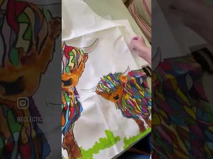 Bright Highland Cow Apron White unboxing video showing a customer unwrapping her Bright Highland Cow Apron On White.  