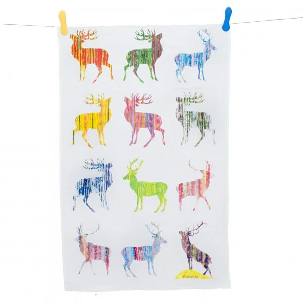 Colourful Stag Tea Towel (Multi) hanging by pegs on washing line on white background.